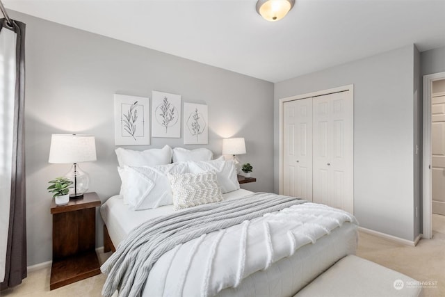 bedroom featuring light colored carpet and a closet