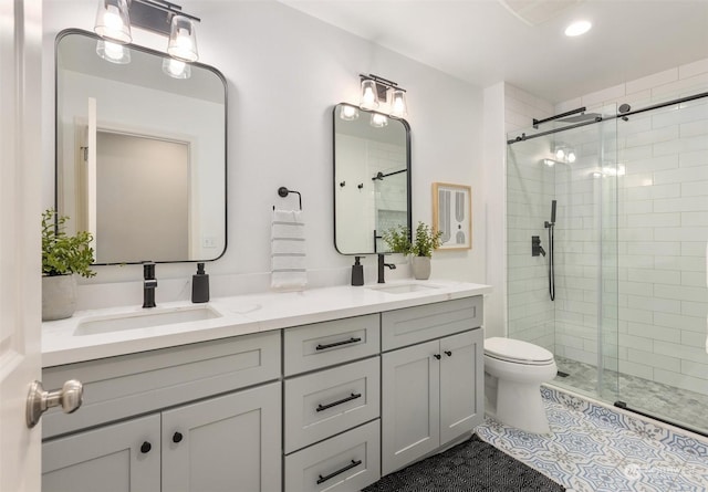 bathroom with vanity, toilet, and a shower with shower door