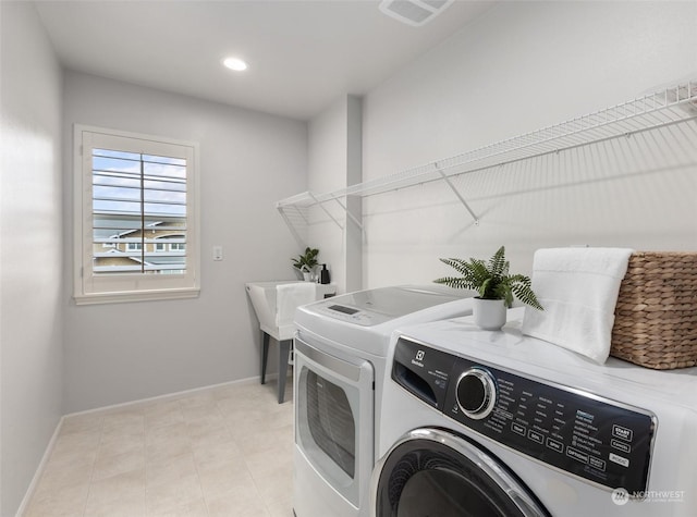 laundry area with washing machine and dryer