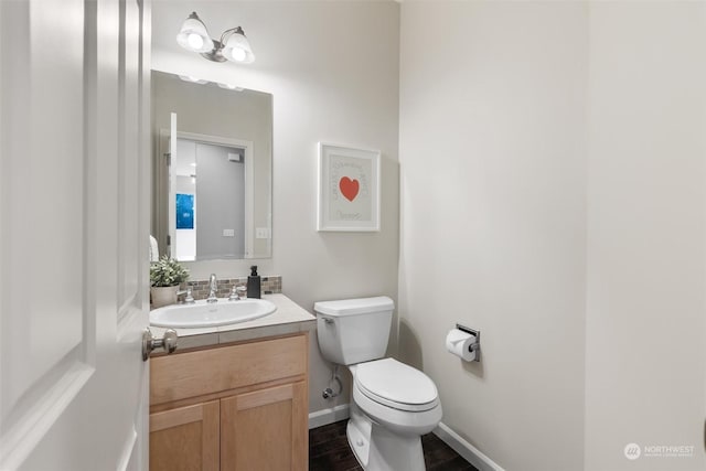 bathroom with vanity, wood-type flooring, and toilet