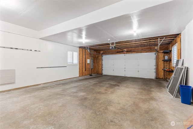 garage featuring a garage door opener and electric panel