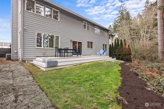 rear view of property featuring a yard, a deck, and central air condition unit