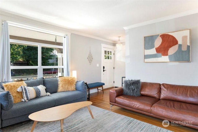 living room featuring crown molding, wood-type flooring, and a healthy amount of sunlight