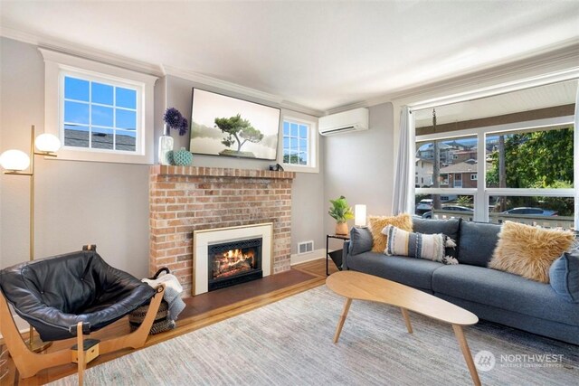 living room featuring a fireplace, ornamental molding, an AC wall unit, and wood-type flooring