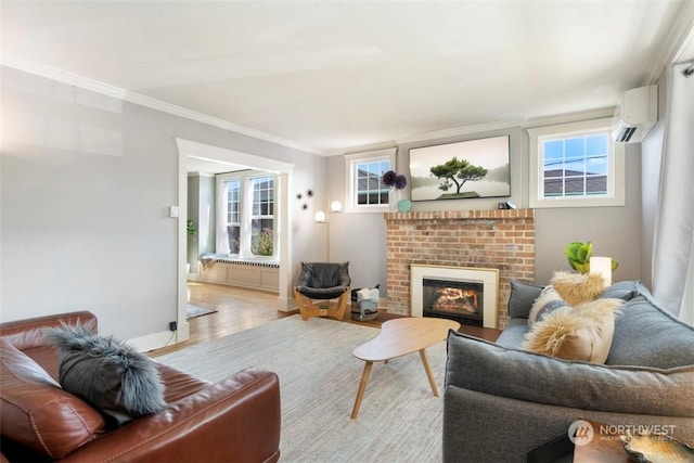 living room with ornamental molding, plenty of natural light, a wall mounted AC, and a fireplace