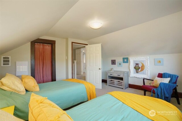 bedroom with lofted ceiling and light colored carpet