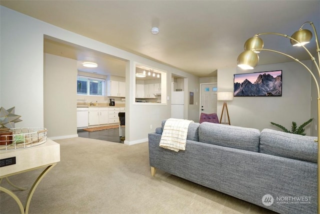 carpeted living room with sink