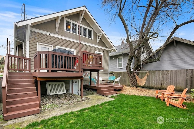 rear view of house with a deck and a lawn