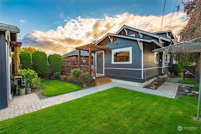 view of front of home featuring a yard and a pergola