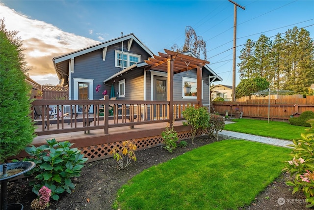 back of house featuring a yard and a deck