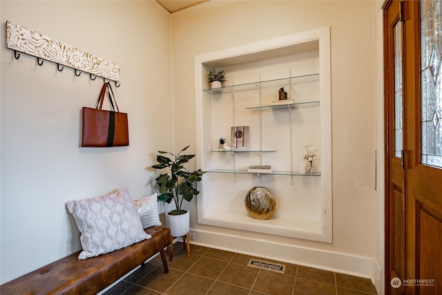 mudroom featuring dark tile patterned flooring