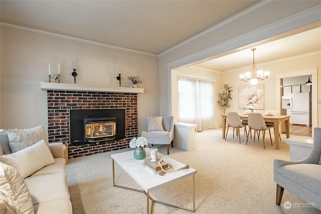 carpeted living room featuring ornamental molding, a notable chandelier, and a fireplace