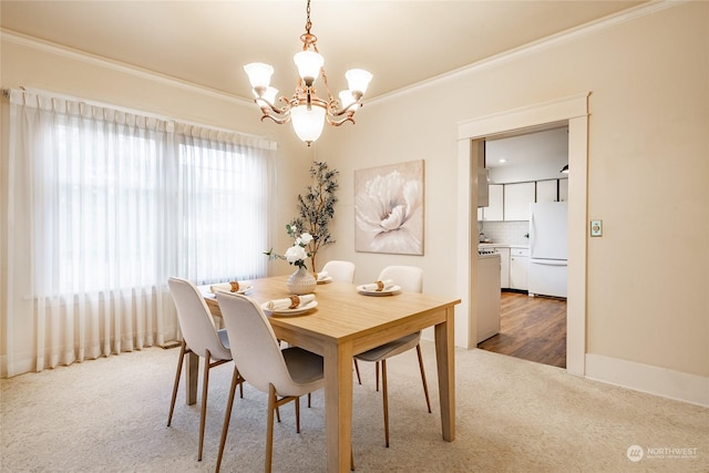 carpeted dining area with crown molding and an inviting chandelier