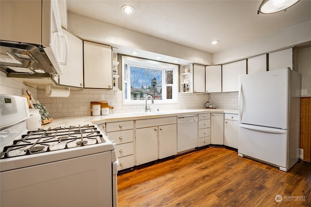 kitchen with sink, white cabinetry, light hardwood / wood-style flooring, white appliances, and decorative backsplash