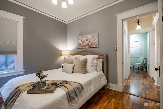 bedroom with dark wood-type flooring and ornamental molding