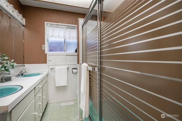 bathroom with vanity and a shower with door