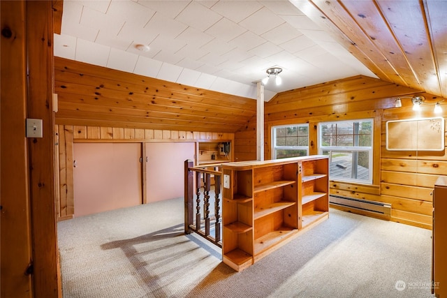 bonus room featuring vaulted ceiling, light colored carpet, wood walls, and baseboard heating