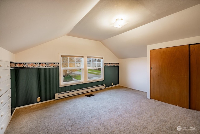 additional living space featuring lofted ceiling, carpet flooring, and baseboard heating