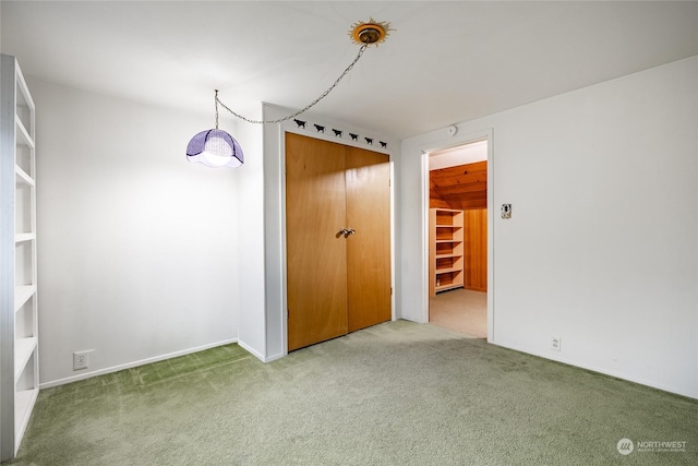 unfurnished bedroom with carpet flooring and a closet