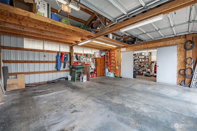 garage with a garage door opener and a workshop area