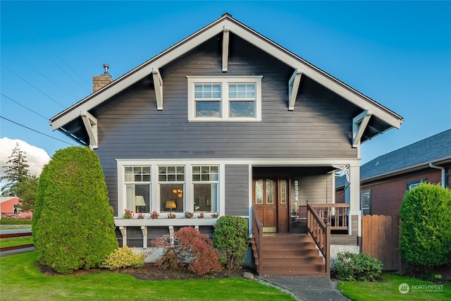 rear view of house with covered porch