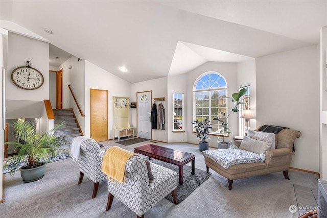 carpeted living room featuring lofted ceiling