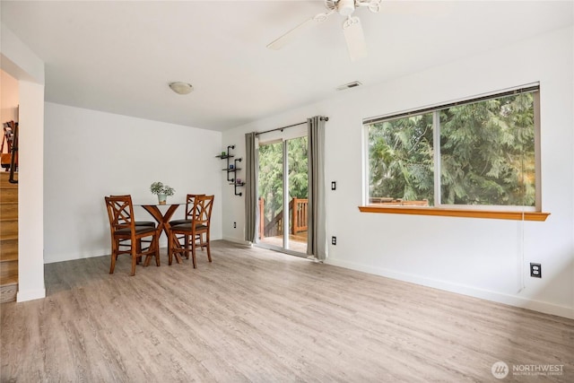 dining area with visible vents, baseboards, a ceiling fan, and wood finished floors