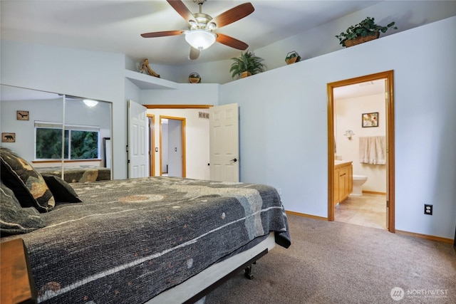 bedroom featuring baseboards, light carpet, connected bathroom, and a ceiling fan