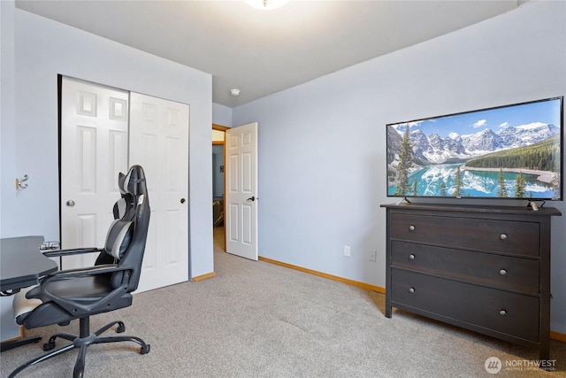 carpeted home office featuring baseboards