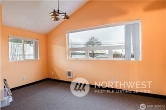 bonus room with an inviting chandelier, vaulted ceiling, and carpet