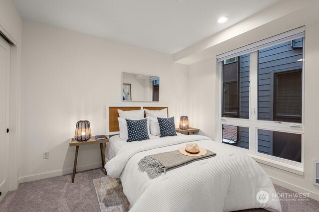 bedroom featuring light colored carpet and a closet