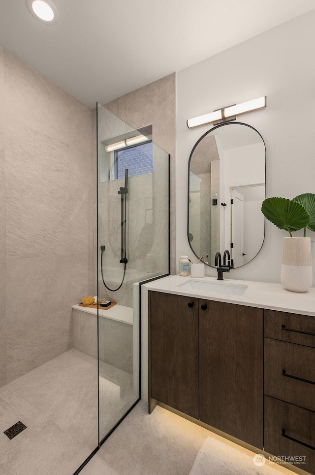 bathroom with vanity and tiled shower