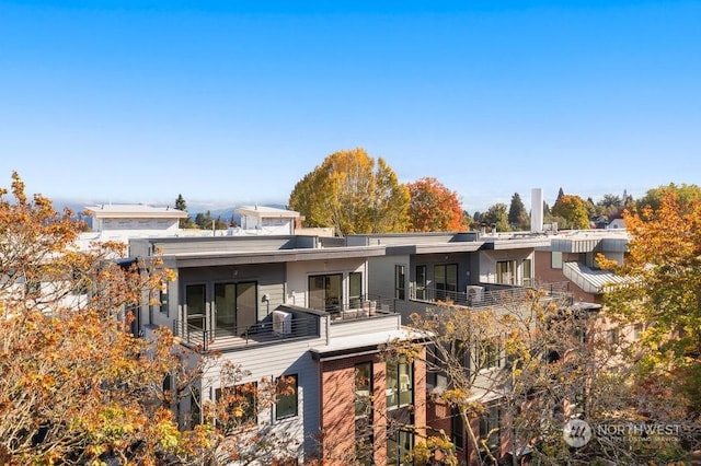 rear view of property with a balcony