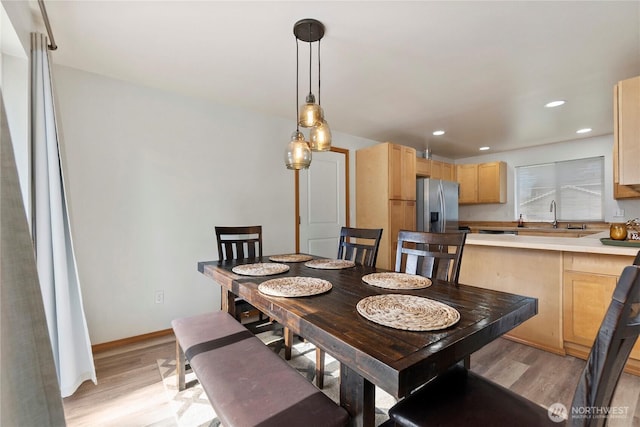 dining area featuring recessed lighting, light wood-type flooring, and baseboards