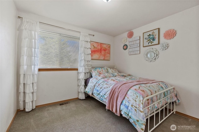 carpeted bedroom featuring baseboards and visible vents