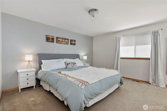 carpeted bedroom featuring visible vents and baseboards