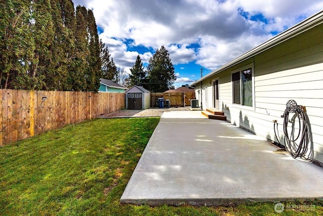 view of yard with entry steps, a fenced backyard, a storage shed, an outdoor structure, and a patio area