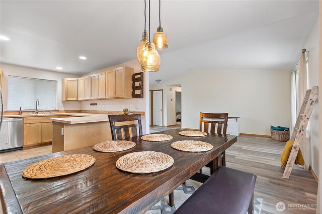 dining area with lofted ceiling, recessed lighting, baseboards, and light wood finished floors