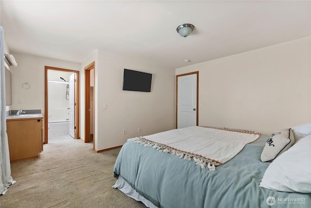 bedroom with light colored carpet, connected bathroom, and baseboards