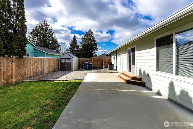 view of yard with an outbuilding, central AC unit, entry steps, a storage unit, and a patio area