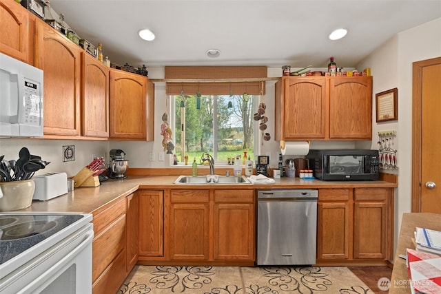 220 California St, Pe Ell, WA 98572 - kitchen featuring white appliances, a sink, light countertops, recessed lighting, and brown cabinets