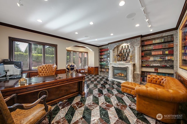 office area with built in shelves and ornamental molding