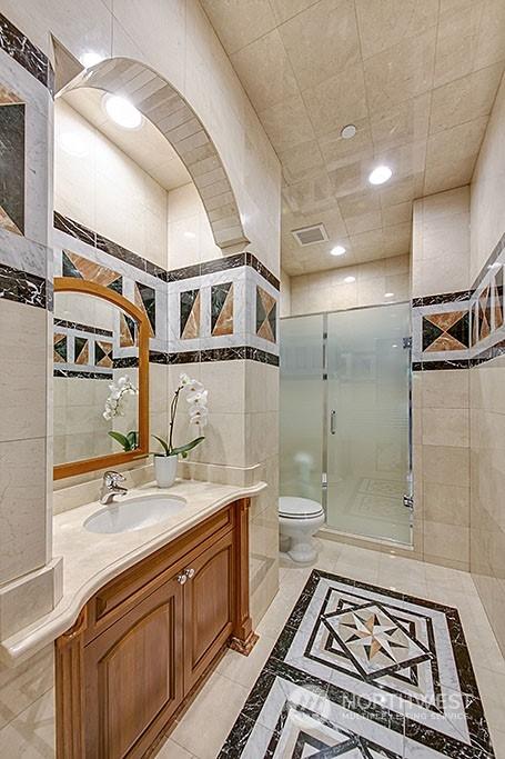 bathroom featuring vanity, tile walls, an enclosed shower, and toilet