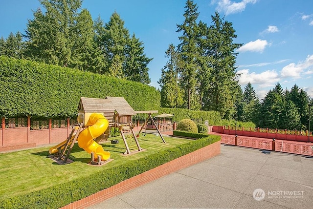 view of playground with a lawn