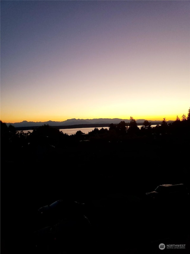 nature at dusk featuring a water and mountain view