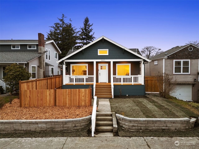 view of front of home with a porch and a garage