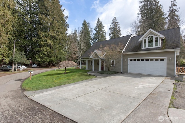 view of front of house featuring driveway, a garage, and a front yard