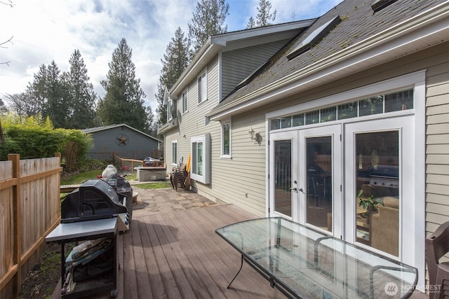 wooden deck featuring french doors and fence
