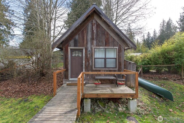 view of outbuilding with fence