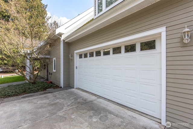 garage featuring concrete driveway
